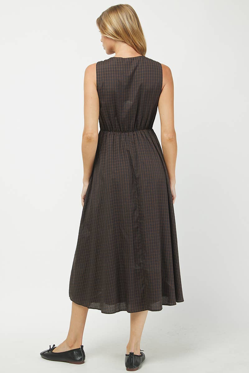 Woman wearing a black checkered dress on a white background