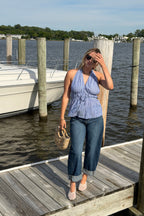 Woman lying on a wooden dock by the water