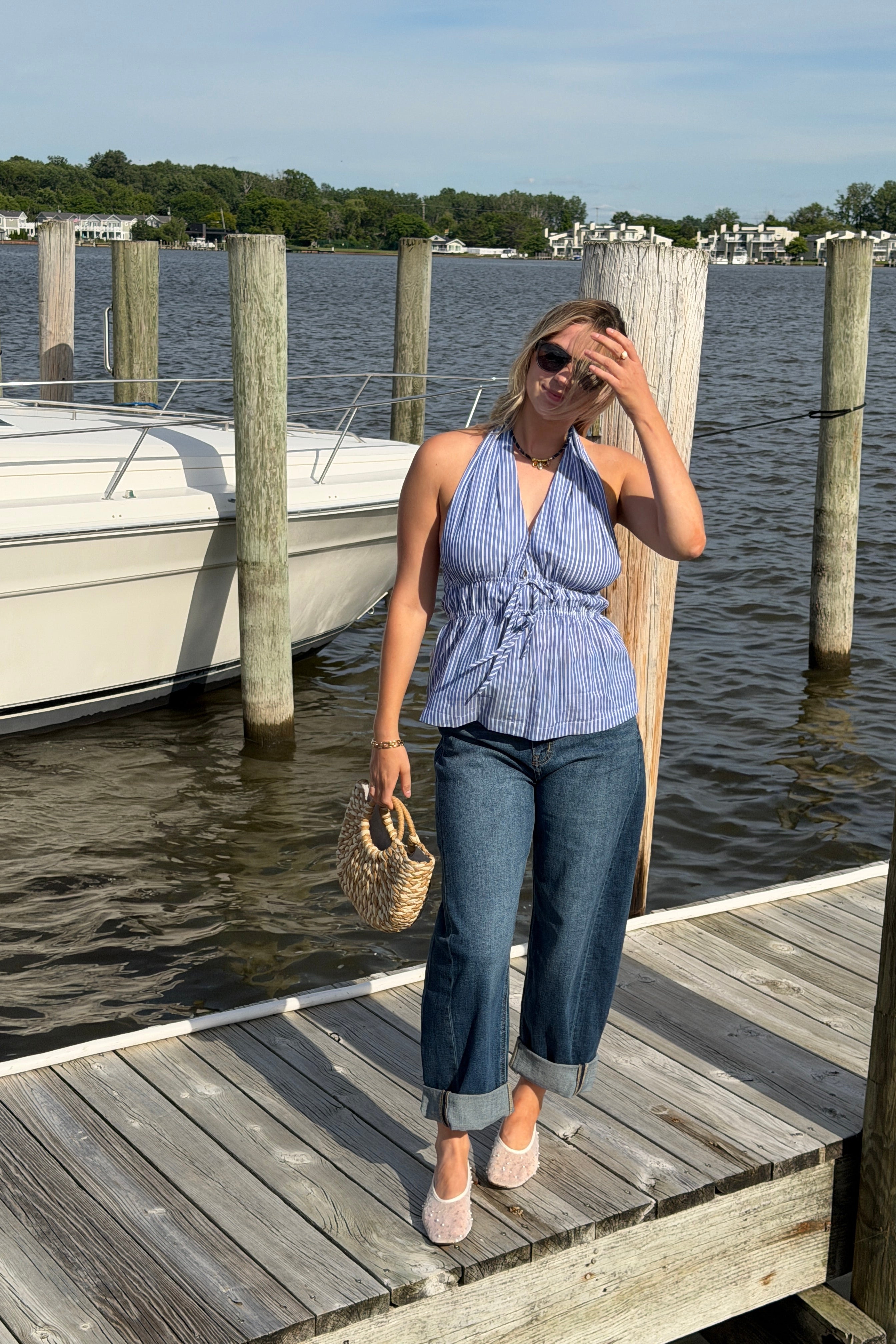 Woman lying on a wooden dock by the water