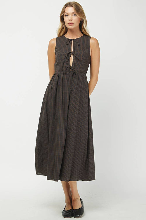 Woman wearing a brown checkered dress on a white background