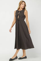 Woman wearing a black patterned dress on a white background