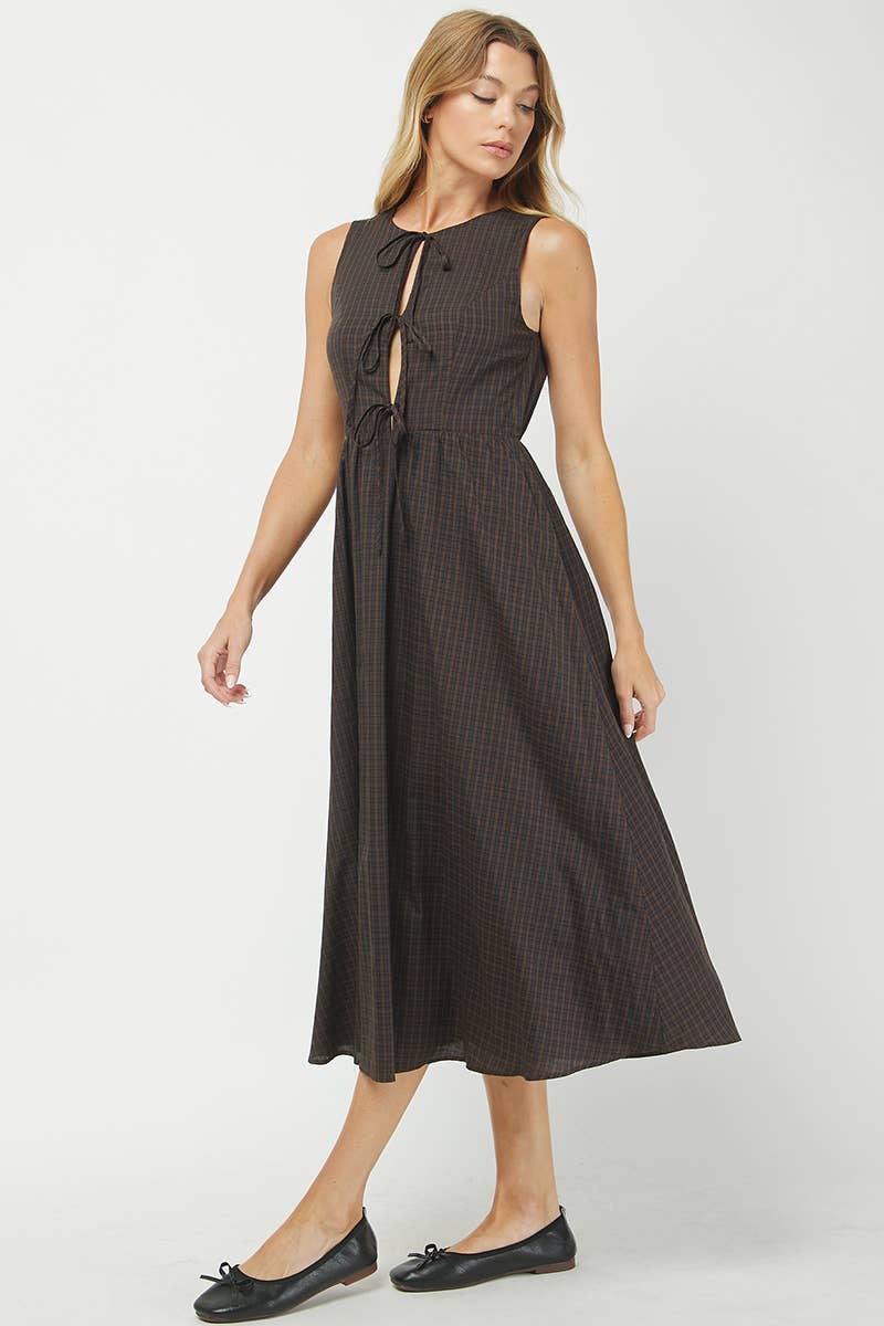 Woman wearing a black patterned dress on a white background