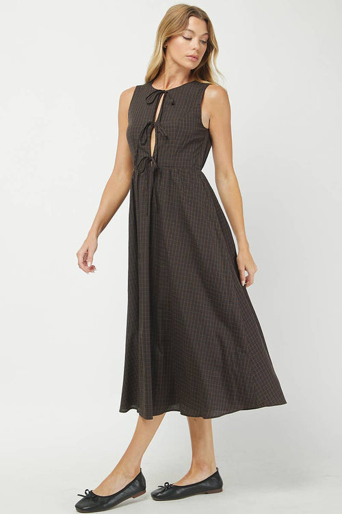 Woman wearing a black patterned dress on a white background